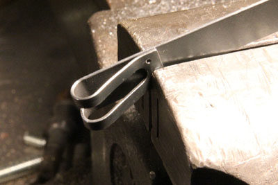 A closer view of the end of the Zundapp KS601 battery strap, ready for a rivet.